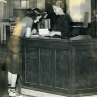 Grace Chaires (Librarian, 1937-1969) at circulation desk
